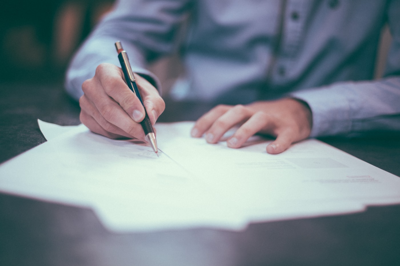 A person reviewing and signing documents